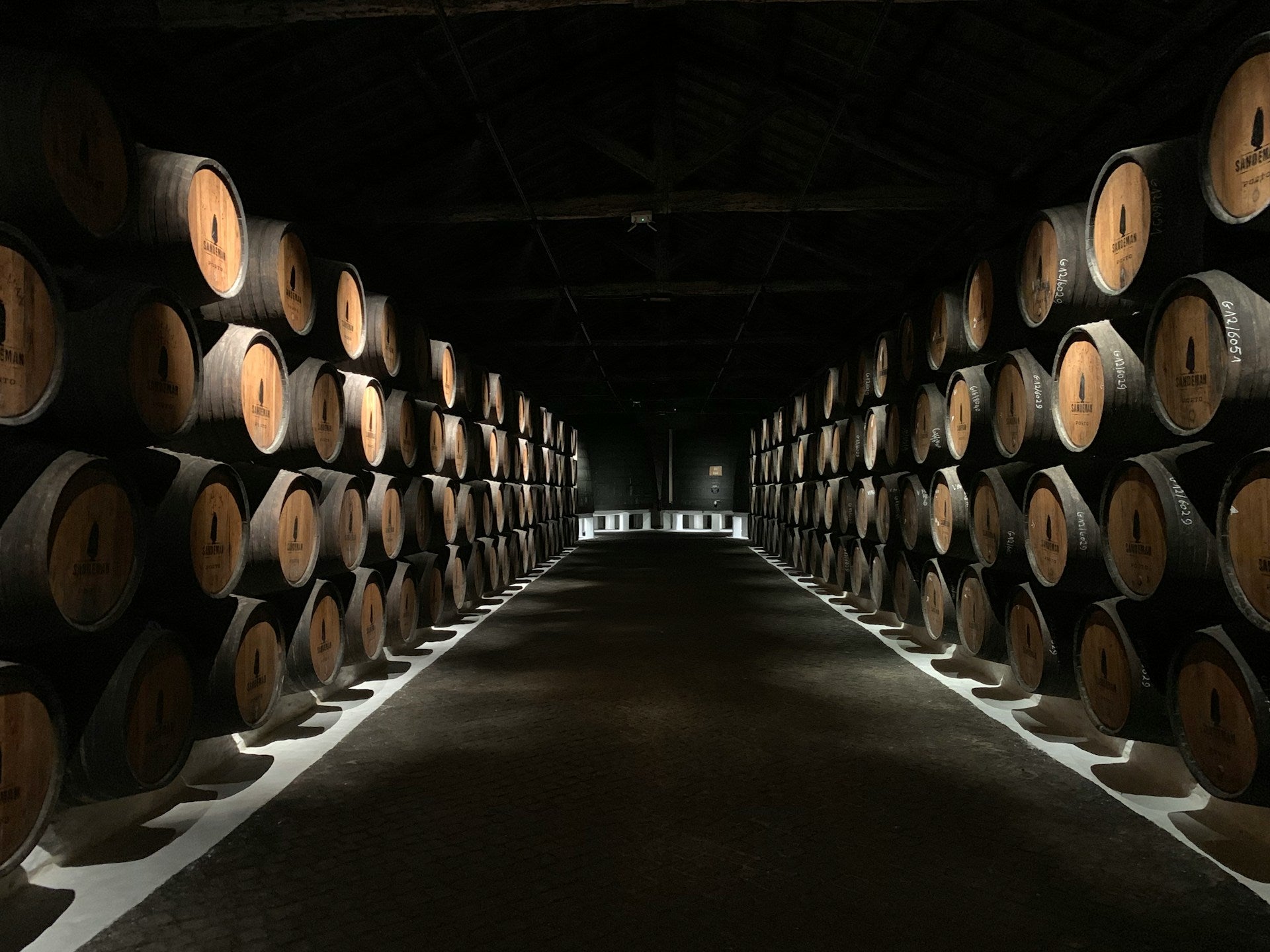 An underground cellar of oak casks filled with whisky.