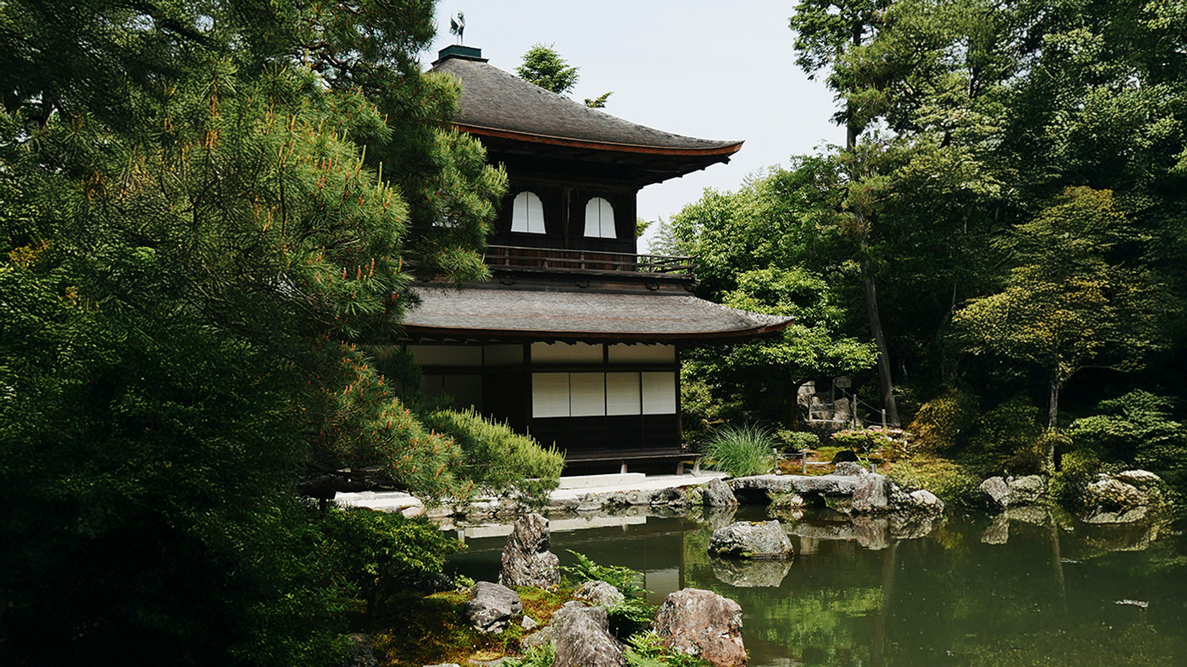 A scenic landscape surrounding a temple in Japan.