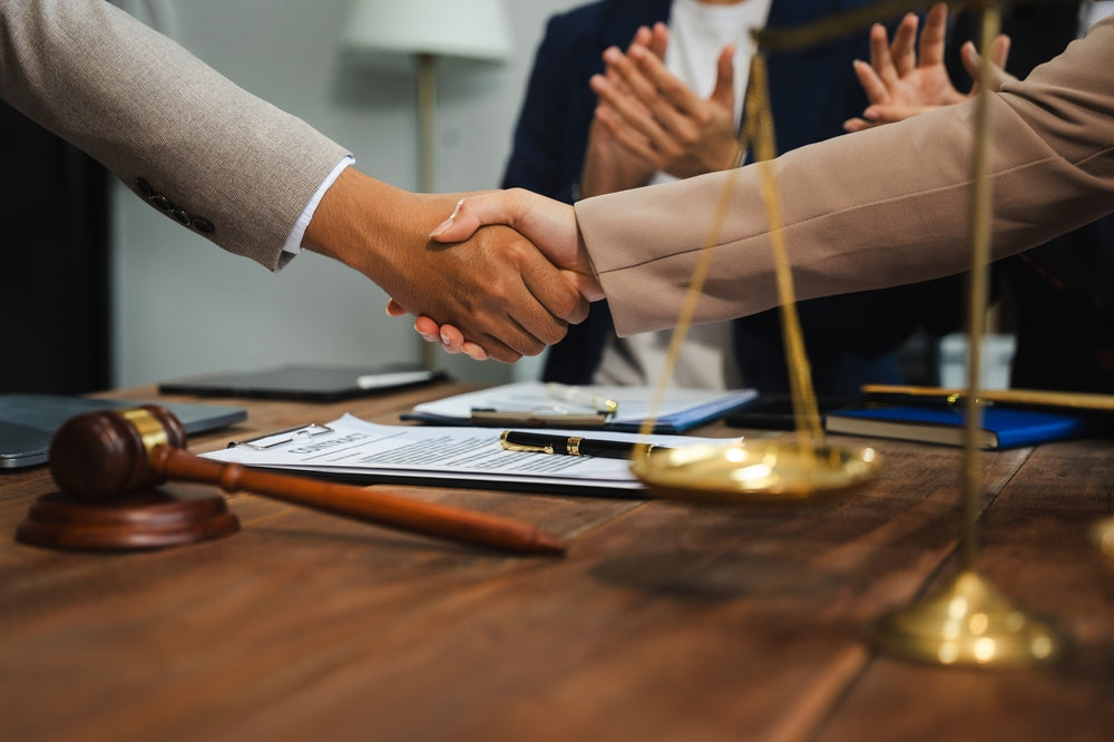 Two men shaking hands over a deal made at auction.
