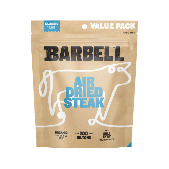 A brown resealable bag labeled Barbell Classic Air Dried Steak Organic Grass Fed Beef, featuring a cow outline. The packaging highlights 200g protein-rich biltong with no bullsh*t ingredients.