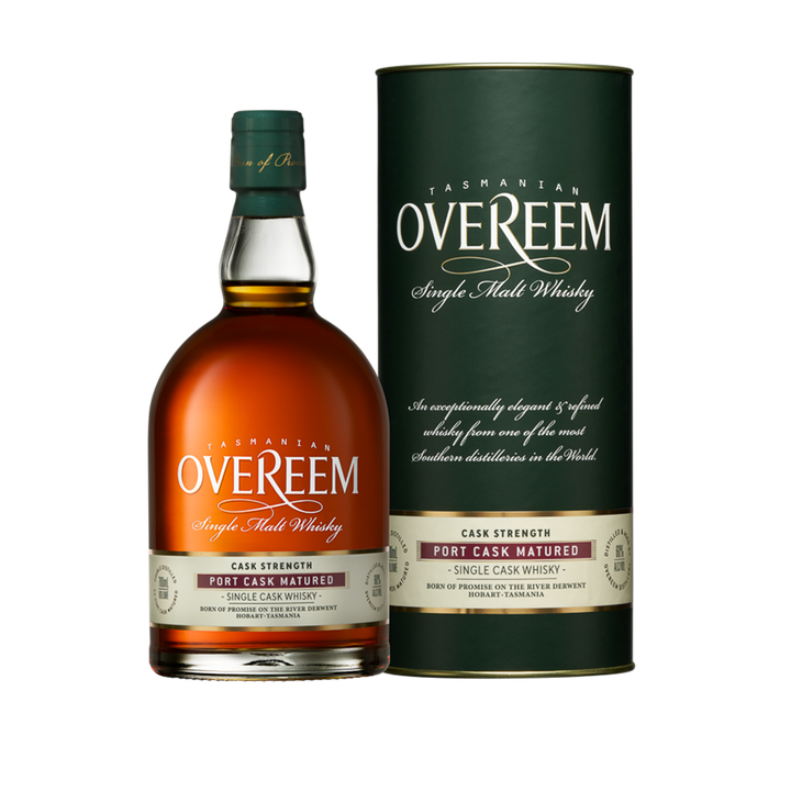 A bottle of Overeem Port Cask Matured - Cask Strength Australian Single Malt Whisky stands next to its matching green cylindrical box, both labeled cask strength and port cask matured. The amber spirit suggests rich flavors within.