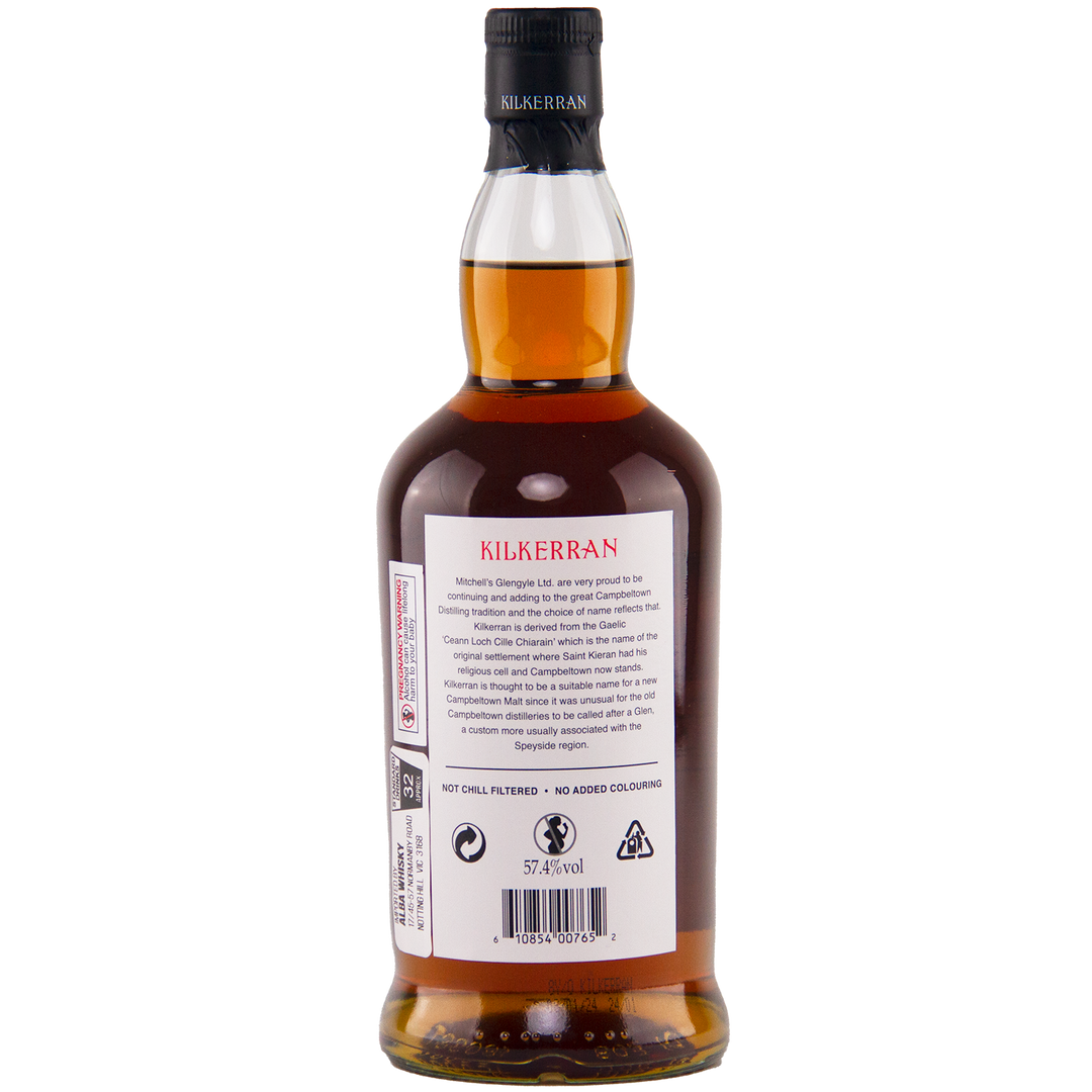 The back of a Kilkerran 8 Year Old Sherry Cask Strength Single Malt Scotch Whisky (2024 Release) bottle displays detailed branding and product information, with the amber liquid visible through the clear glass.