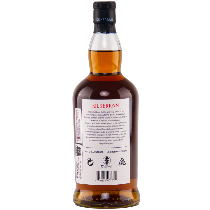The back of a Kilkerran 8 Year Old Sherry Cask Strength Single Malt Scotch Whisky (2024 Release) bottle displays detailed branding and product information, with the amber liquid visible through the clear glass.