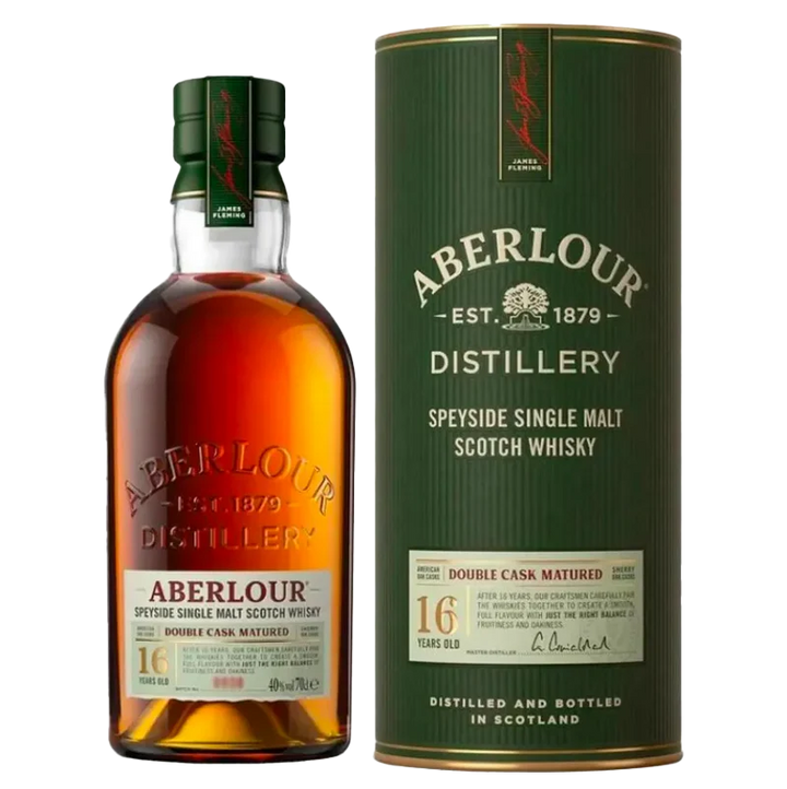 A bottle of Aberlour 16 Year Old Double Cask Single Malt Scotch Whisky stands beside its cylindrical box, both adorned with gold, cream, and green labels featuring red accents that highlight its renowned double cask maturation.