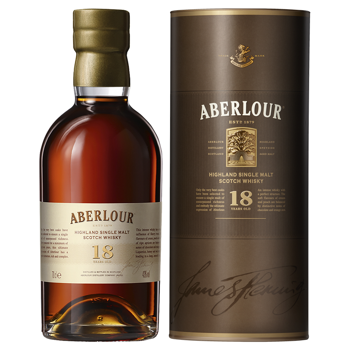 A bottle of Aberlour 18 Year Old Single Malt Scotch Whisky stands next to its cylindrical packaging, both featuring gold and cream labels with the Aberlour name displayed prominently.