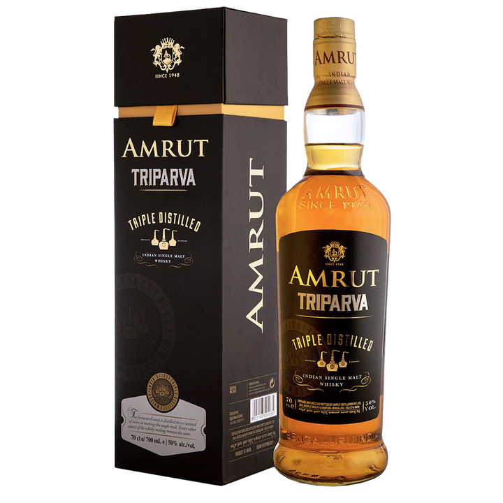A bottle of Amrut Triparva Indian Single Malt whisky is displayed beside its sleek black and gold box, both adorned with gold lettering and accents emphasizing the whisky's signature triple distillation.