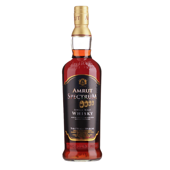 A bottle of Amrut Spectrum Indian Single Malt Whisky with a black and gold label highlights its innovative cask maturation and renowned single malt qualities, set against a plain white background.
