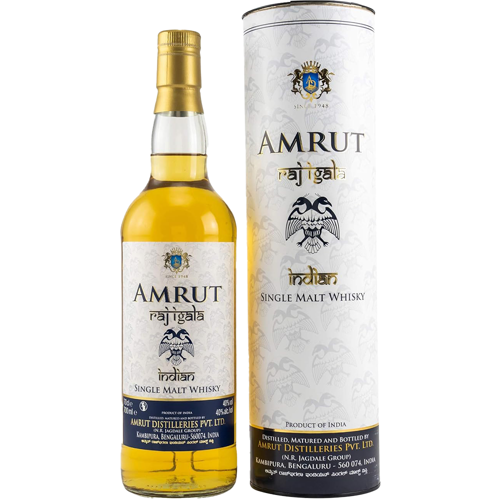A bottle of Amrut Raj Igala Indian Single Malt Whisky is displayed beside its cylindrical packaging, both featuring a gold and white label with blue accents, a branded crest, and a bold black eagle illustration.