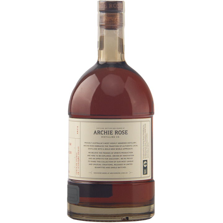 A 700ml bottle of Archie Rose Chocolate Rye Malt Whisky with dark amber liquid, cork-sealed and featuring a cream and gold label, is shown on a plain white background.