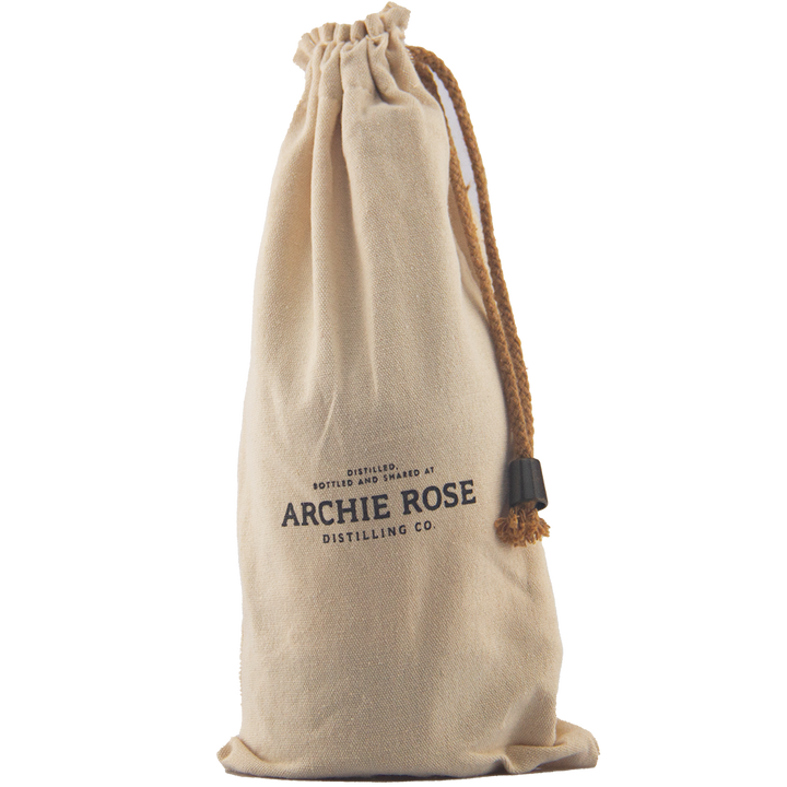 A beige drawstring cloth bag with “Archie Rose Distilling Co.” in black on the front stands upright against a plain background—perfect for gifting or presenting Archie Rose Chocolate Rye Malt Whisky 700ml.