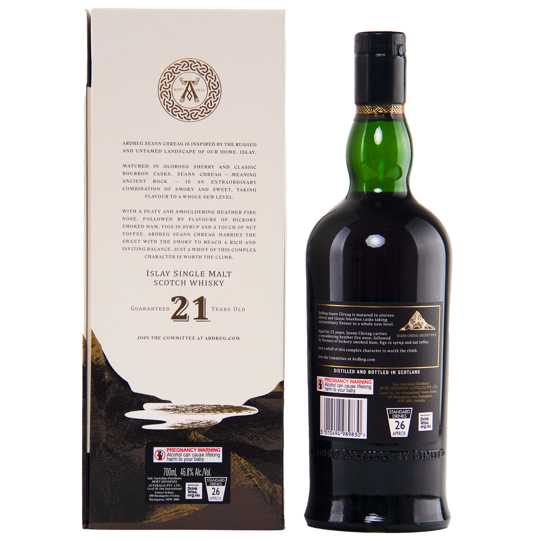 A dark green bottle of Ardbeg 21 Year Old Seann Chreag Single Malt Scotch Whisky stands beside its cream-colored box, with black and gold accents and detailed product information in black text.