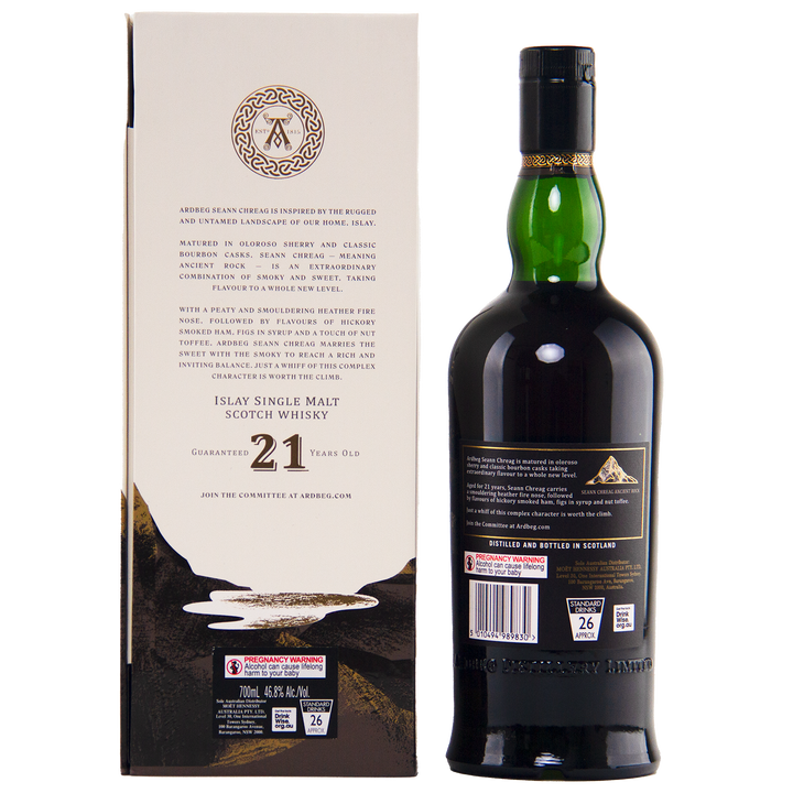 A dark green bottle of Ardbeg 21 Year Old Seann Chreag Single Malt Scotch Whisky stands beside its cream-colored box, with black and gold accents and detailed product information in black text.