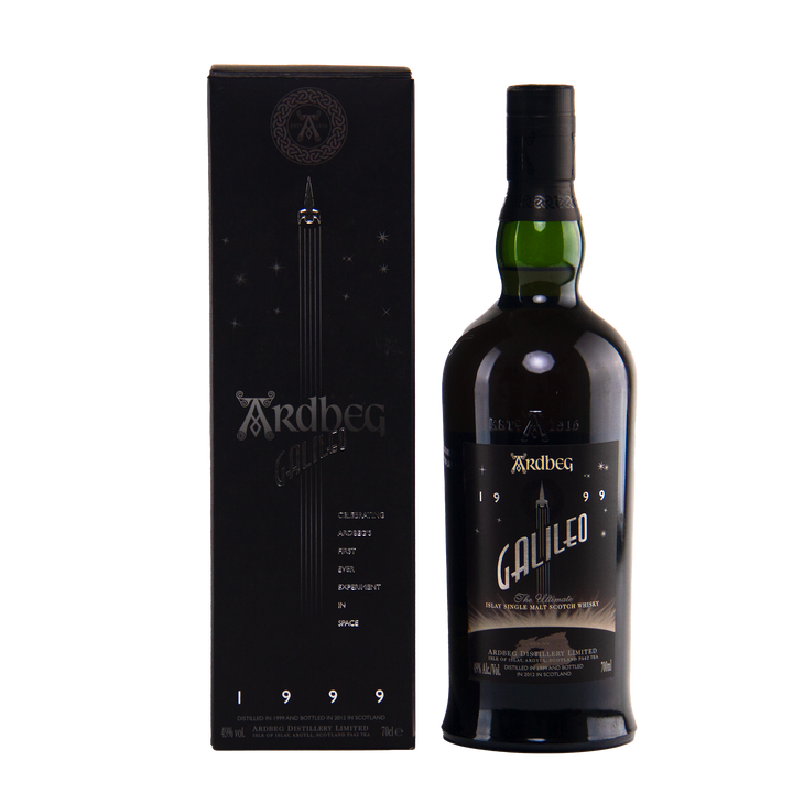 A dark bottle of Ardbeg Galileo Limited Edition Single Malt Scotch Whisky stands beside its black and gold box, decorated with space-themed graphics and text including "1999" and "Distilled & bottled in Scotland.