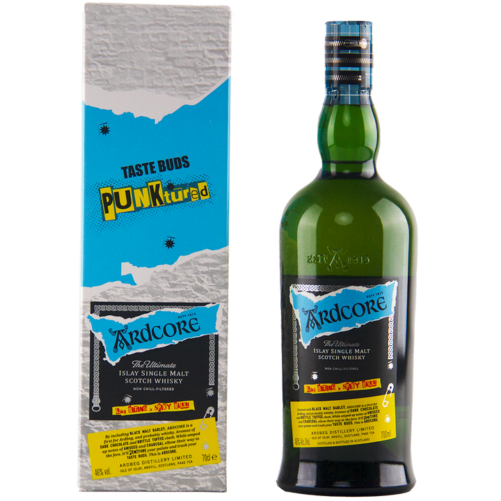 A bottle of Ardbeg Ardcore Single Malt Scotch Whisky Ardbeg Day 2022 Limited Release stands beside its matching box, both showcasing a punk-inspired design with blue, yellow, and black accents and the phrase "Taste Buds Punktured.