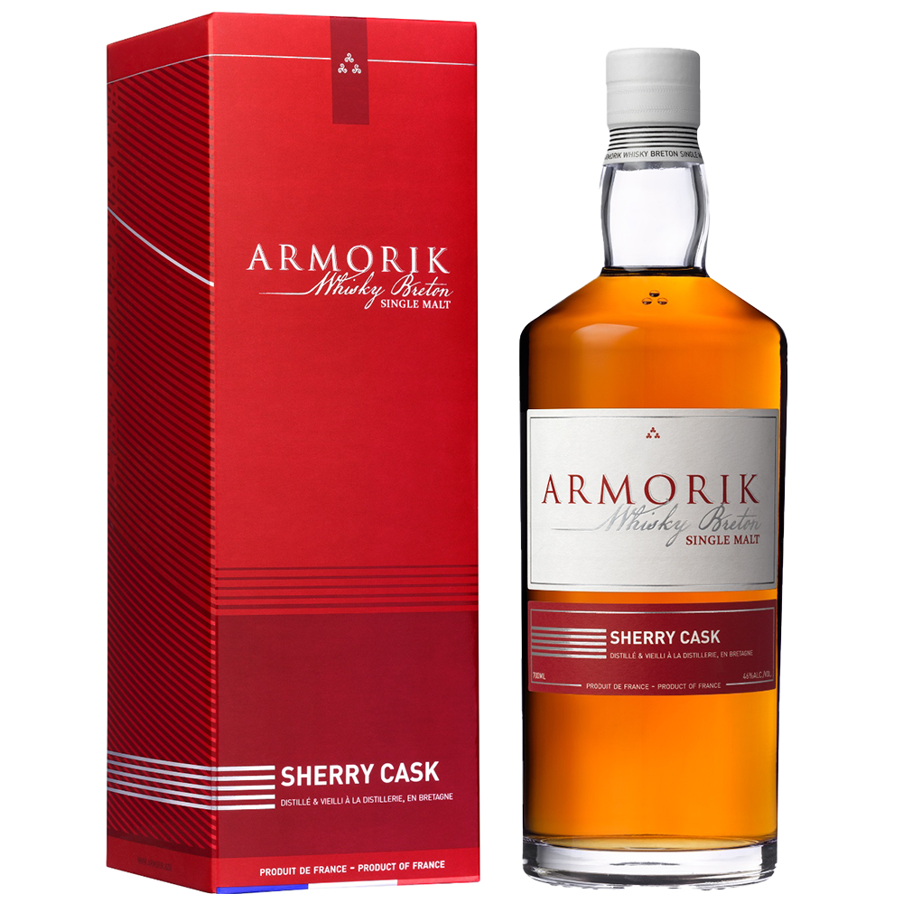 A bottle of Armorik Sherry Cask French Single Malt Whisky stands beside its red and white box, both featuring brand details in French and English that highlight the whisky's sherry cask maturation.