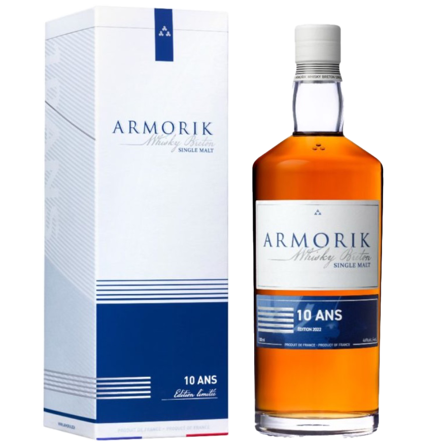 A bottle of Armorik 10 Ans (10 Year Old) French Single Malt Whisky stands beside its blue and white box, both featuring modern design and elegant text. Crafted at Warenghem Distillery, the whisky is amber-colored.