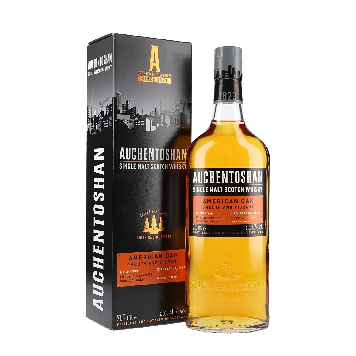A bottle of Auchentoshan American Oak Single Malt Scotch Whisky is shown next to its black and orange box with a city skyline graphic and "Smooth and Vibrant" text.
