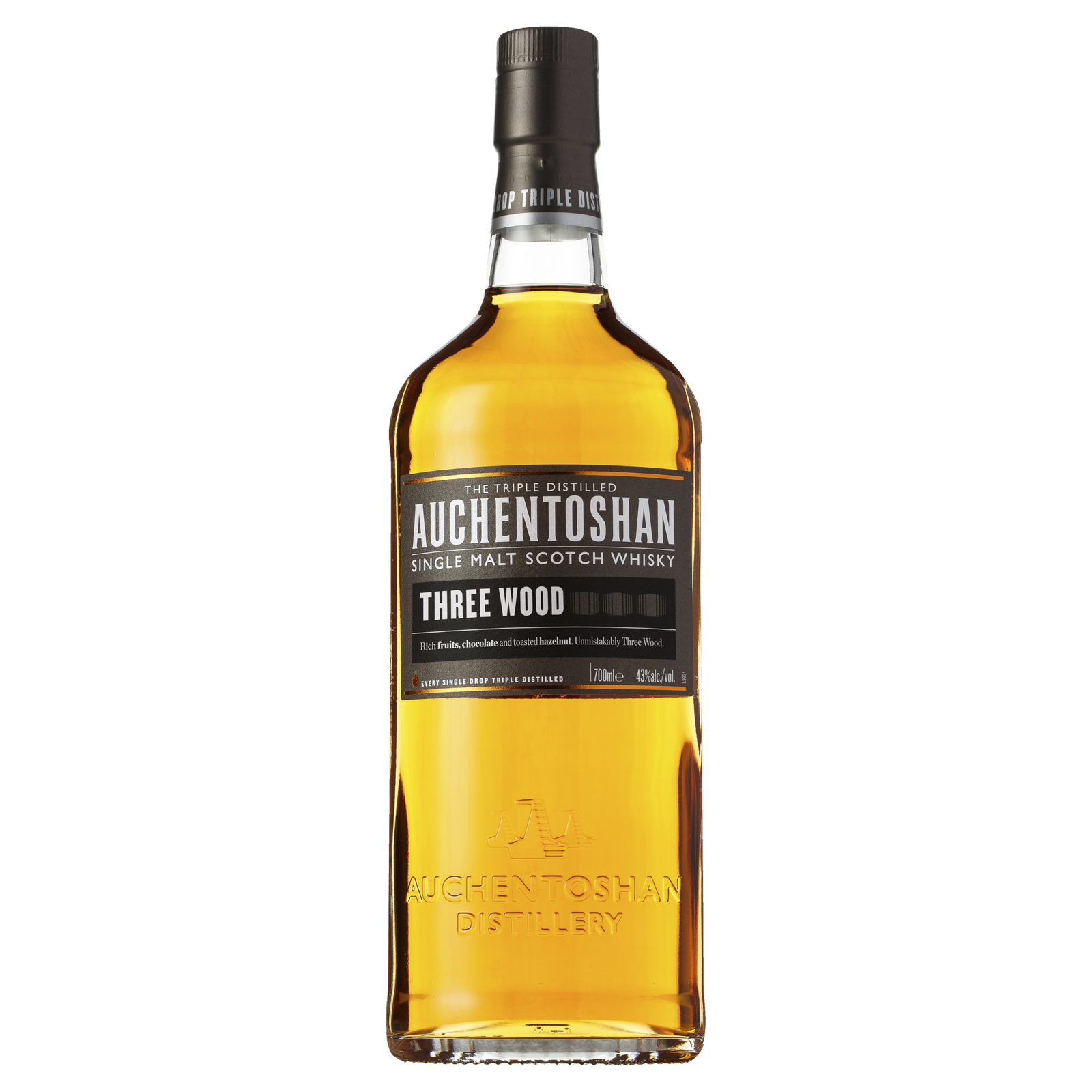 A bottle of Auchentoshan Three Wood Single Malt Scotch Whisky with a black label, gold accents, and amber liquid is shown against a plain white background, highlighting its signature triple maturation process.