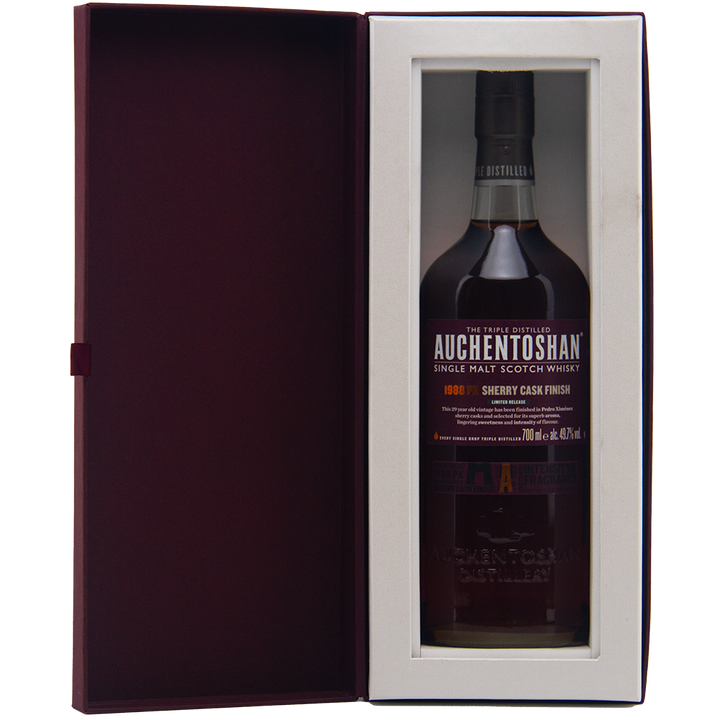 A bottle of Auchentoshan 1988 PX Sherry Cask Finish Single Malt Scotch Whisky comes in a gift box with a clear window and dark red interior, highlighting Pedro Ximénez sherry notes and the whisky’s signature smooth triple distillation.