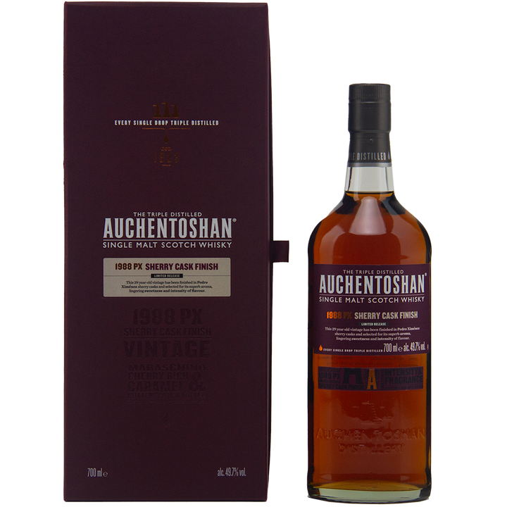 A bottle of Auchentoshan 1988 PX Sherry Cask Finish Single Malt Scotch Whisky, triple distilled and matured in Pedro Ximénez sherry casks, stands next to its dark purple box with silver and gold text on a plain background.