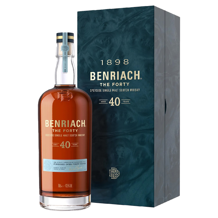 A bottle of Benriach The Forty Single Malt Scotch Whisky stands beside its blue marbled box, decorated with gold and white text highlighting the brand and age.