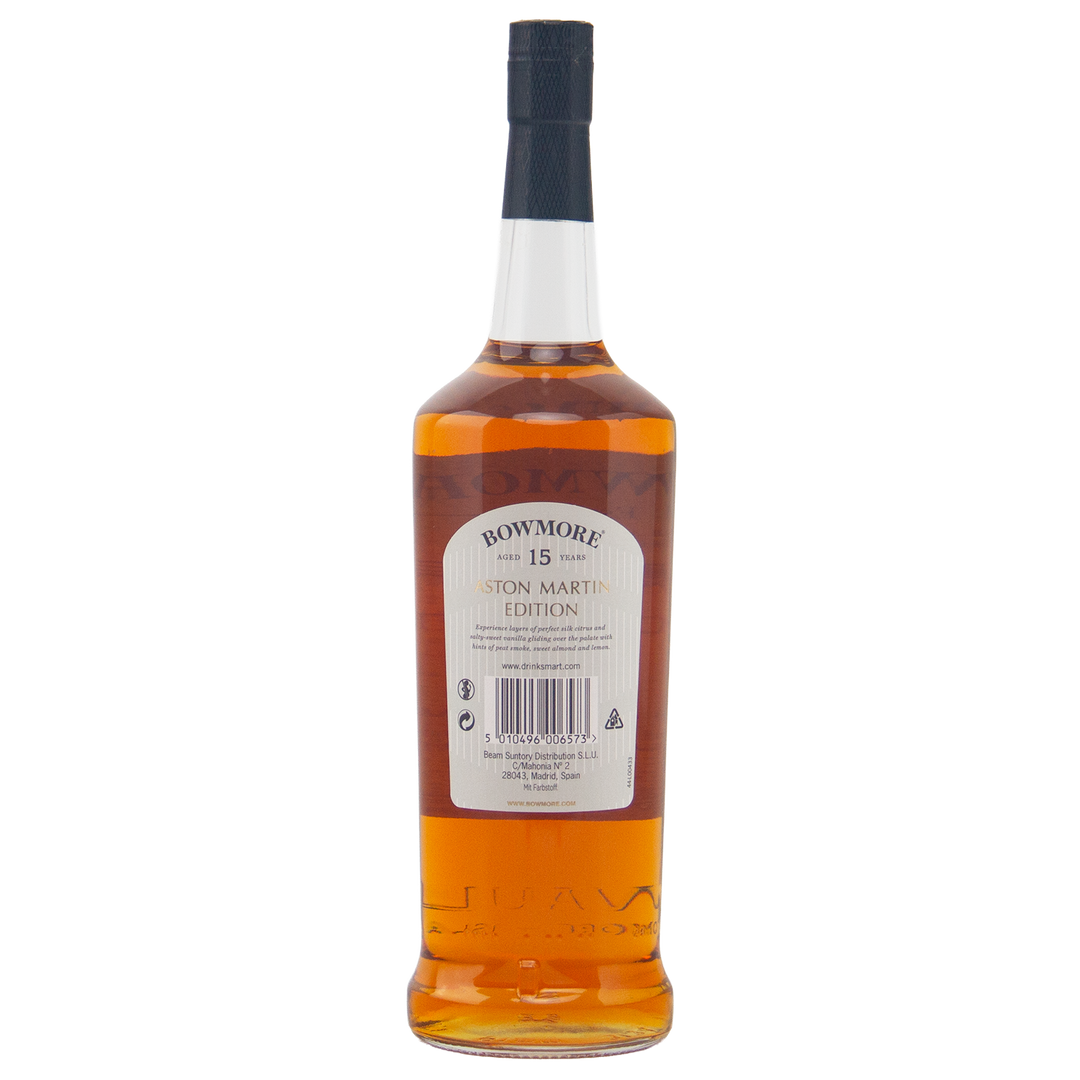 A bottle of Bowmore 15 Year Old Aston Martin Edition #2 Single Malt Scotch Whisky is shown from the back, featuring a detailed label, barcode, and text on the packaging, filled with rich amber whisky.