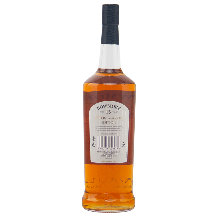 A bottle of Bowmore 15 Year Old Aston Martin Edition #2 Single Malt Scotch Whisky is shown from the back, featuring a detailed label, barcode, and text on the packaging, filled with rich amber whisky.