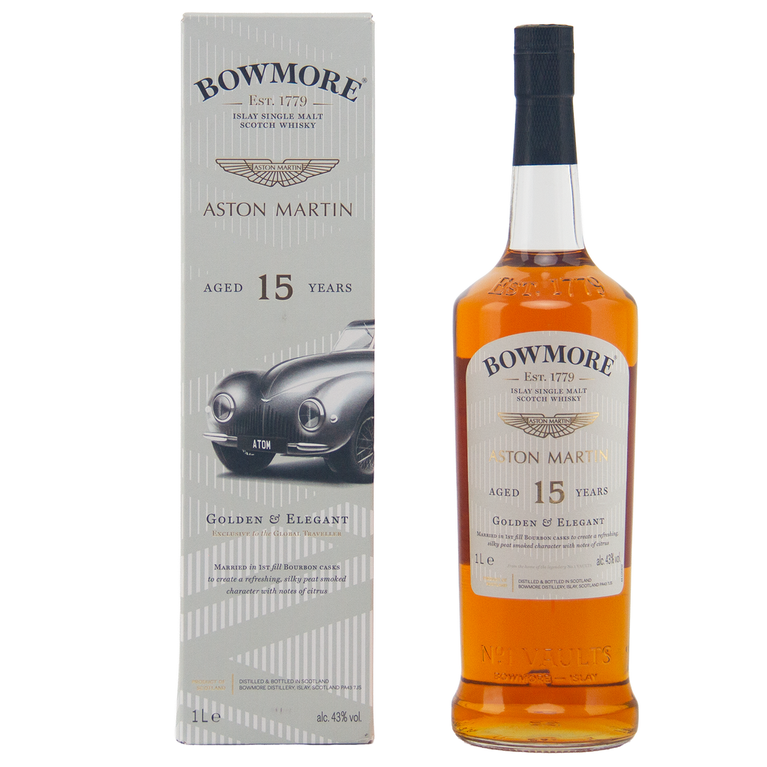 A bottle of Bowmore 15 Year Old Aston Martin Edition #2 Single Malt Scotch Whisky stands beside its box, which features a classic Aston Martin car and gold-silver detailing. The label confirms it’s aged 15 years.