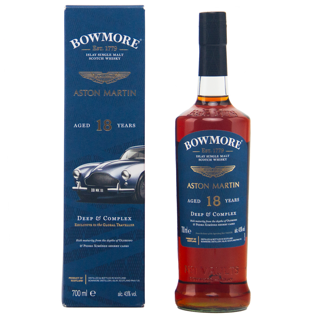 A bottle of Bowmore 18 Year Old Aston Martin Edition #3 Single Malt Scotch Whisky stands by its blue box, featuring a classic Aston Martin car illustration and gold text highlighting the whisky’s age and edition details.