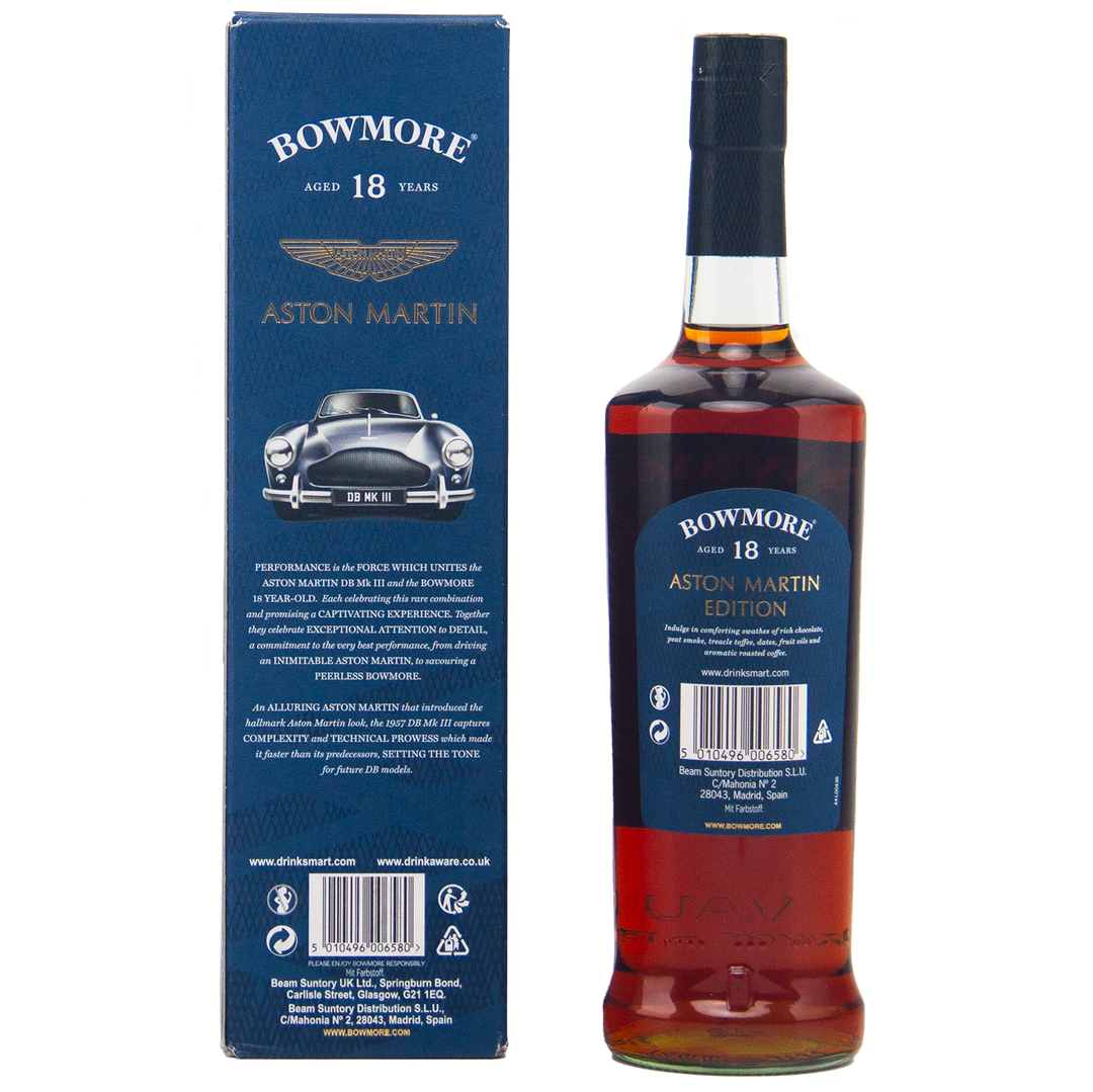 A bottle of Bowmore 18 Year Old Aston Martin Edition #3 Single Malt Scotch Whisky is displayed next to its blue box, featuring a classic Aston Martin car image, gold branding, and detailed product information.