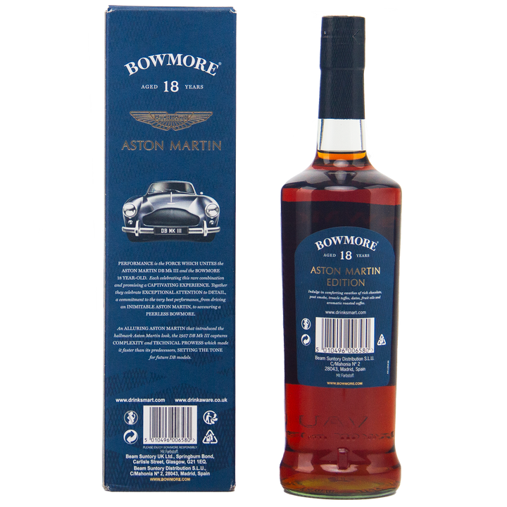 A bottle of Bowmore 18 Year Old Aston Martin Edition #3 Single Malt Scotch Whisky is displayed next to its blue box, featuring a classic Aston Martin car image, gold branding, and detailed product information.