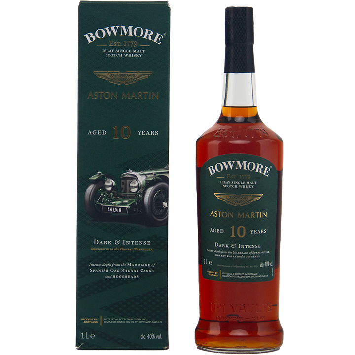 A bottle of Bowmore 10 Year Old Aston Martin Edition 1 Dark & Intense Single Malt Scotch Whisky stands beside its green box, featuring a classic Aston Martin car and gold text showcasing the whisky’s age and character.