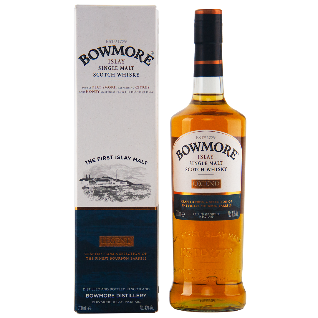 A bottle of Bowmore Legend Islay Single Malt Scotch Whisky stands beside its matching box, both showcasing Islay origins, peated heritage, and golden amber liquid with detailed text on the labels.