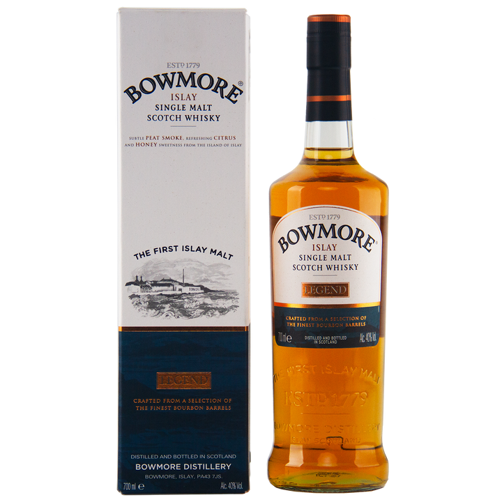 A bottle of Bowmore Legend Islay Single Malt Scotch Whisky stands beside its matching box, both showcasing Islay origins, peated heritage, and golden amber liquid with detailed text on the labels.