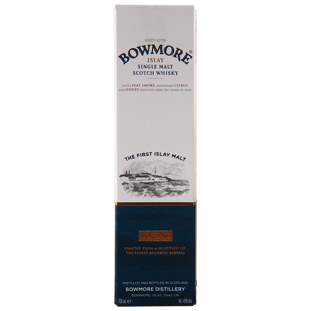 The image displays a tall, rectangular box of Bowmore Legend Islay Single Malt Scotch Whisky, mainly white with a dark blue and gold bottom section and featuring text plus a coastal distillery illustration.