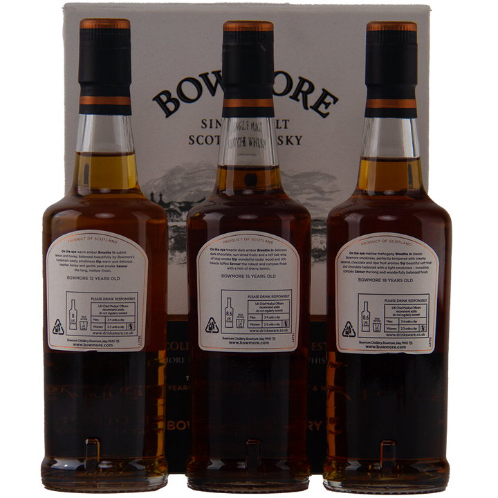 Three bottles from the Bowmore Collection 12, 15 & 18 Year Old (200ml Set) Single Malt Scotch Whisky are displayed in front of a Bowmore box, showing their back labels with product details and recycling instructions.