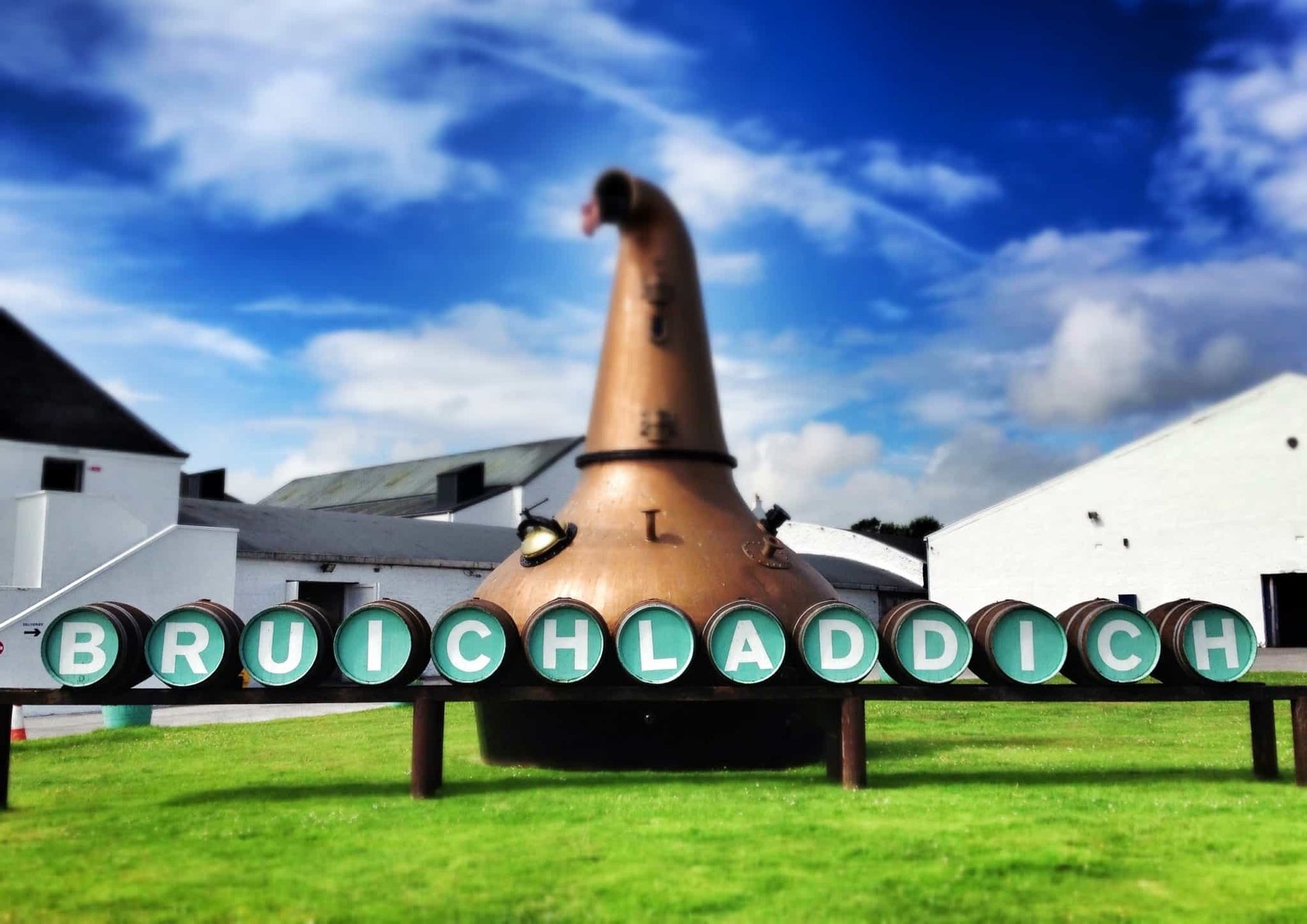 Copper still with 'Bruichladdich' branding against a blue sky