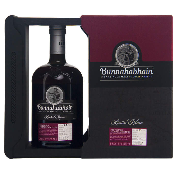 A bottle of Bunnahabhain 30 Year Old 1988 Vintage Islay Single Malt Scotch Whisky in dark glass, presented in a black and burgundy Limited Release Cask Strength box.