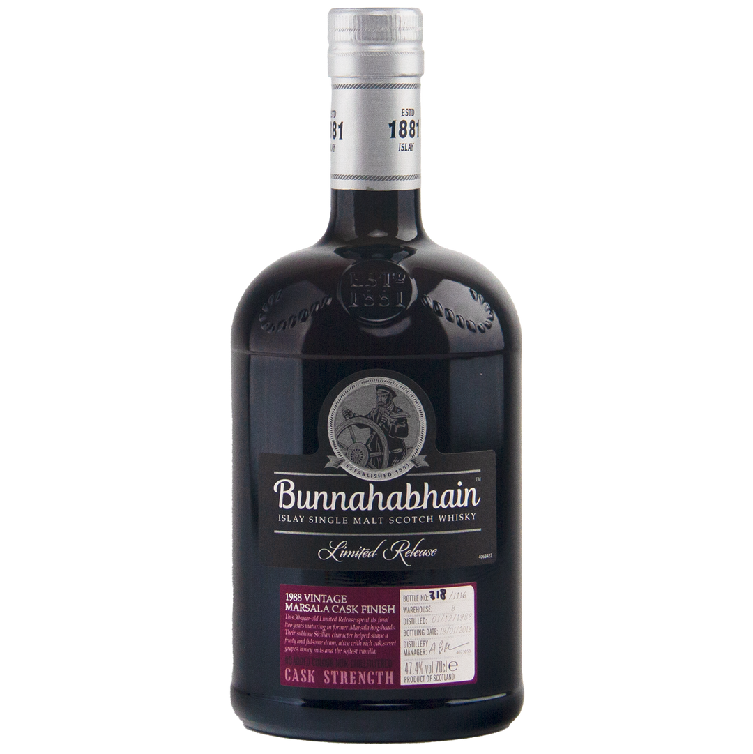 A dark glass bottle of Bunnahabhain 30 Year Old 1988 Vintage single malt whisky, with a silver cap and detailed label indicating it's a limited release, Marsala cask finished, and bottled at cask strength.