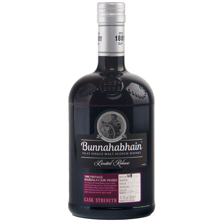 A dark glass bottle of Bunnahabhain 30 Year Old 1988 Vintage single malt whisky, with a silver cap and detailed label indicating it's a limited release, Marsala cask finished, and bottled at cask strength.