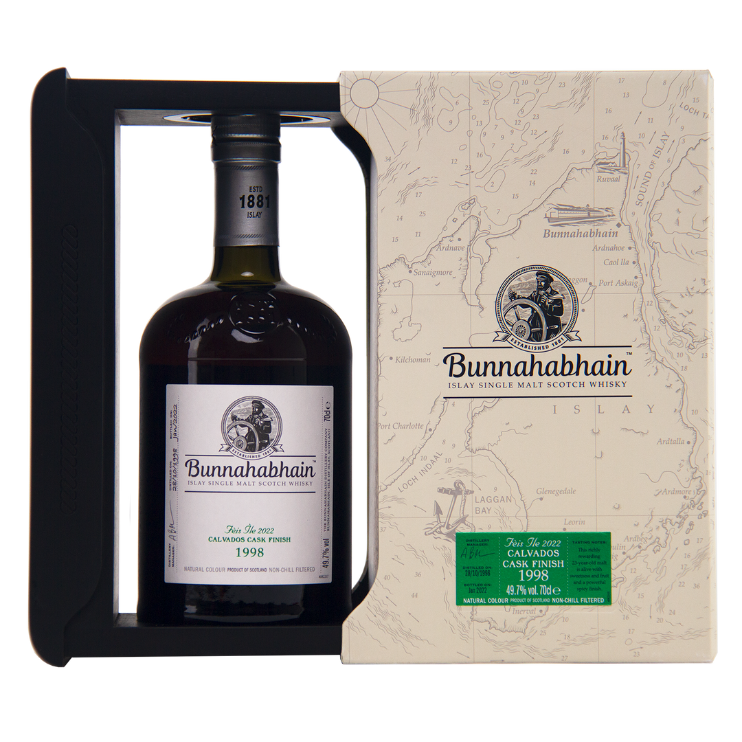 A bottle of Bunnahabhain Fèis Ìle 2022 1998 Calvados Cask Finish is presented in a cream map-themed box with a window that showcases the elegant label.