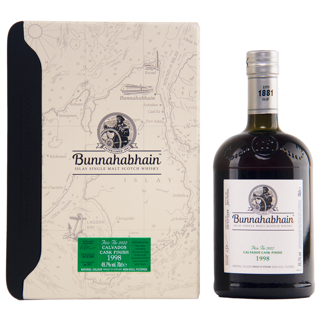 A bottle of Bunnahabhain Fèis Ìle 2022 1998 Calvados Cask Finish sits beside its cream box, adorned with a map design and the Bunnahabhain logo.