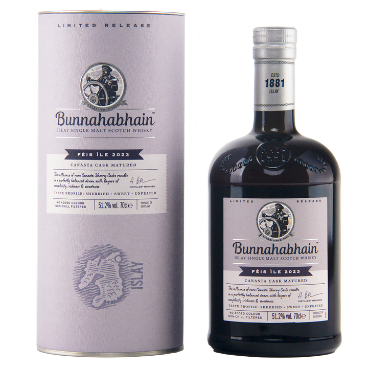A bottle of Bunnahabhain Perth Ile 2023 single malt Scotch whisky next to its matching cylindrical packaging box, both in a clean studio setting.