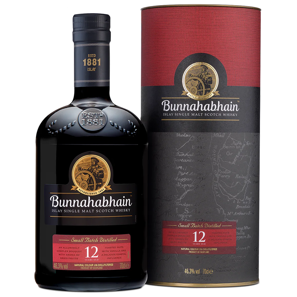 A bottle of Bunnahabhain 12 Year Old Single Malt Scotch Whisky stands beside its matching box, both with black and red labels featuring gold accents and the iconic sailor logo, showcasing this classic Islay single malt.