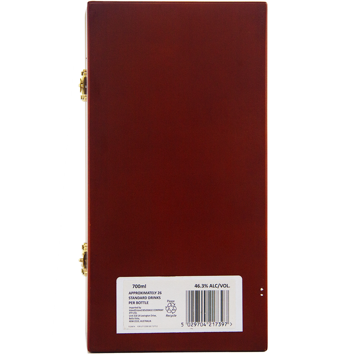 A rectangular wooden box with gold hinges, finished in glossy reddish-brown, is shown from the back. A white label displays a barcode and product details for Bunnahabhain XXV 25 Year Old Single Malt Scotch Whisky.