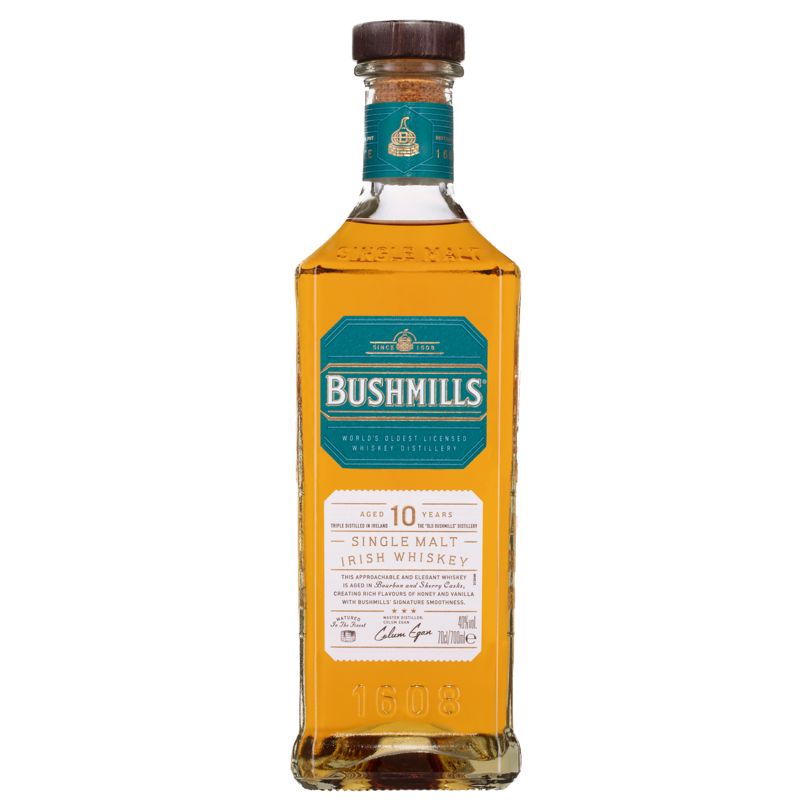A bottle of Bushmills 10 Year Old Single Malt Irish Whiskey features a teal and gold label on clear glass with a dark brown cap, showcasing triple-distilled golden amber whiskey inside.