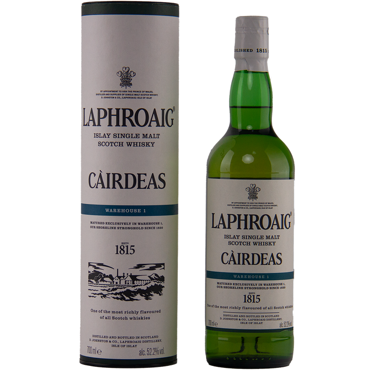 A bottle of Laphroaig Cairdeas 2022 Warehouse 1 whisky stands next to its cylindrical box, both adorned with cream and green labels, black text, and detailed logos.