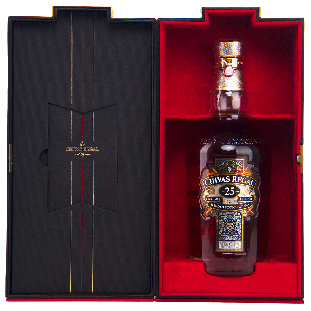 A bottle of Chivas Regal 25 Year Old Blended Scotch Whisky is showcased in an open presentation box lined with black and red velvet, featuring gold lettering and decorative accents.