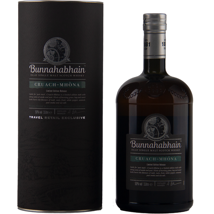 A dark bottle of Bunnahabhain Cruach Mhona Single Malt Scotch Whisky stands next to its tall black cylindrical box, both with matching white and green labels—this Islay whisky is celebrated for its rich peated character.