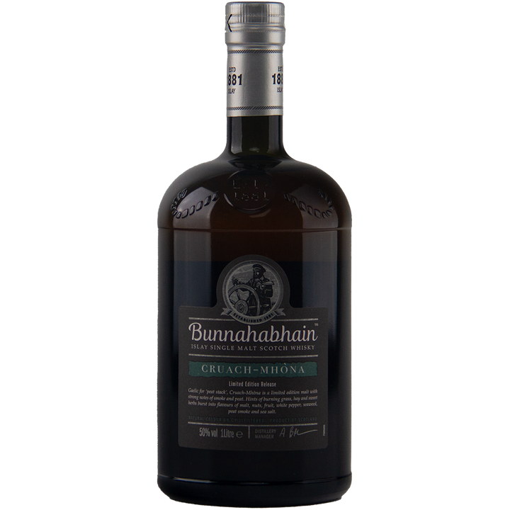 A dark glass bottle of Bunnahabhain Cruach Mhona Single Malt Scotch Whisky, with a black and silver label accented with green and a silver cap, is displayed against a plain light background.